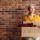 senior-woman-holding-cardboard-box-with-items-to-donate